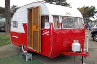 Photo shows a restored 1956 Shasta 1400 trailer with no wings on the side